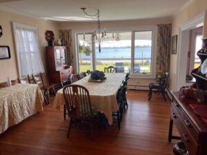 A dining room with a view of the water.