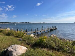 A dock on the water near some rocks