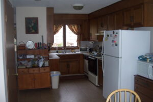 A kitchen with wooden cabinets and white appliances.