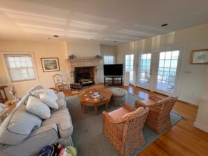 A living room with couches, chairs and a television.