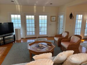 A living room with couches, chairs and tables.