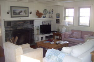 A living room with couches, chairs and a fireplace.