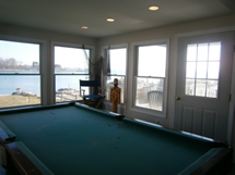 A man standing in front of a pool table.