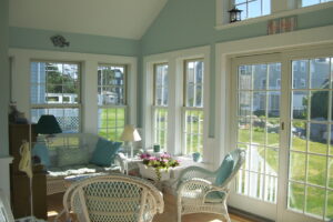 A room with many windows and chairs in it