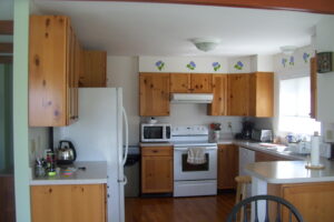 A kitchen with wooden cabinets and white appliances.