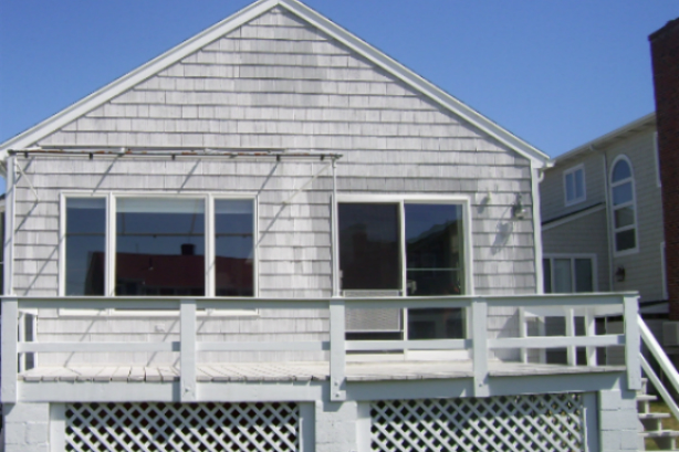 A house with white siding and a blue sky