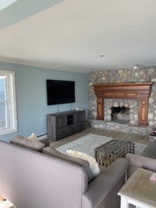 A living room with a fireplace and a flat screen tv.