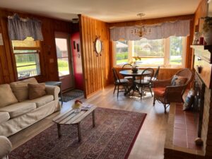 A living room with wood paneling and a couch.