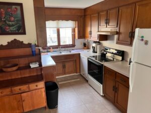 A kitchen with wooden cabinets and white appliances.