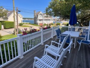 A deck with chairs and an umbrella on it