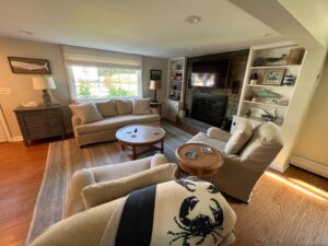 A living room with couches, chairs and a television.