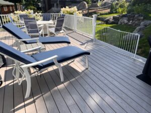 A deck with chairs and tables on it