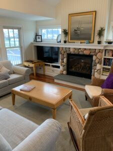 A living room with furniture and a fireplace.