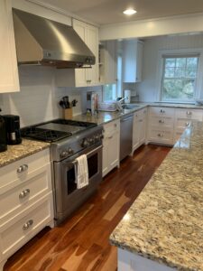 A kitchen with granite counter tops and stainless steel appliances.