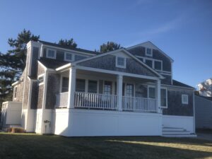 A large house with a porch and a deck.