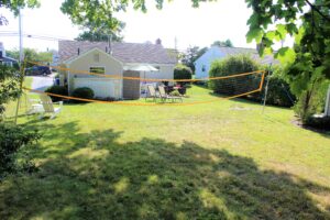 A backyard with a volleyball net and table