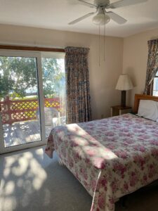 A bedroom with a bed and a balcony