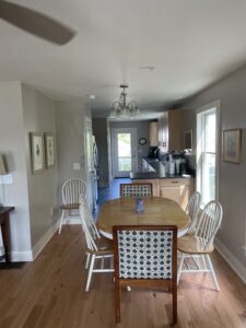 A dining room table with four chairs in it.