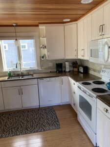 A kitchen with white cabinets and appliances in it