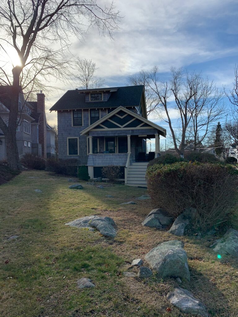 A house with rocks and trees in the background