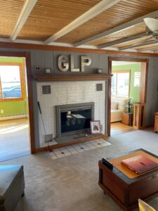 A living room with a fireplace and two tables