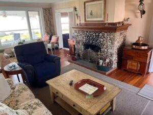 A living room with a fireplace and a blue chair