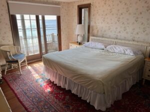 A large bed in the middle of a room with a view.