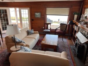 A living room with couches, chairs and tables.