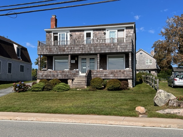 A house with a large yard and some bushes