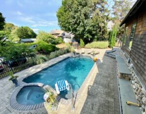 A pool with a jacuzzi and a bench in the middle of it