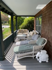 A porch with a lot of furniture on it